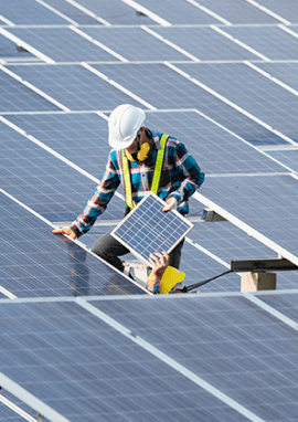 Worker inspecting solar panels